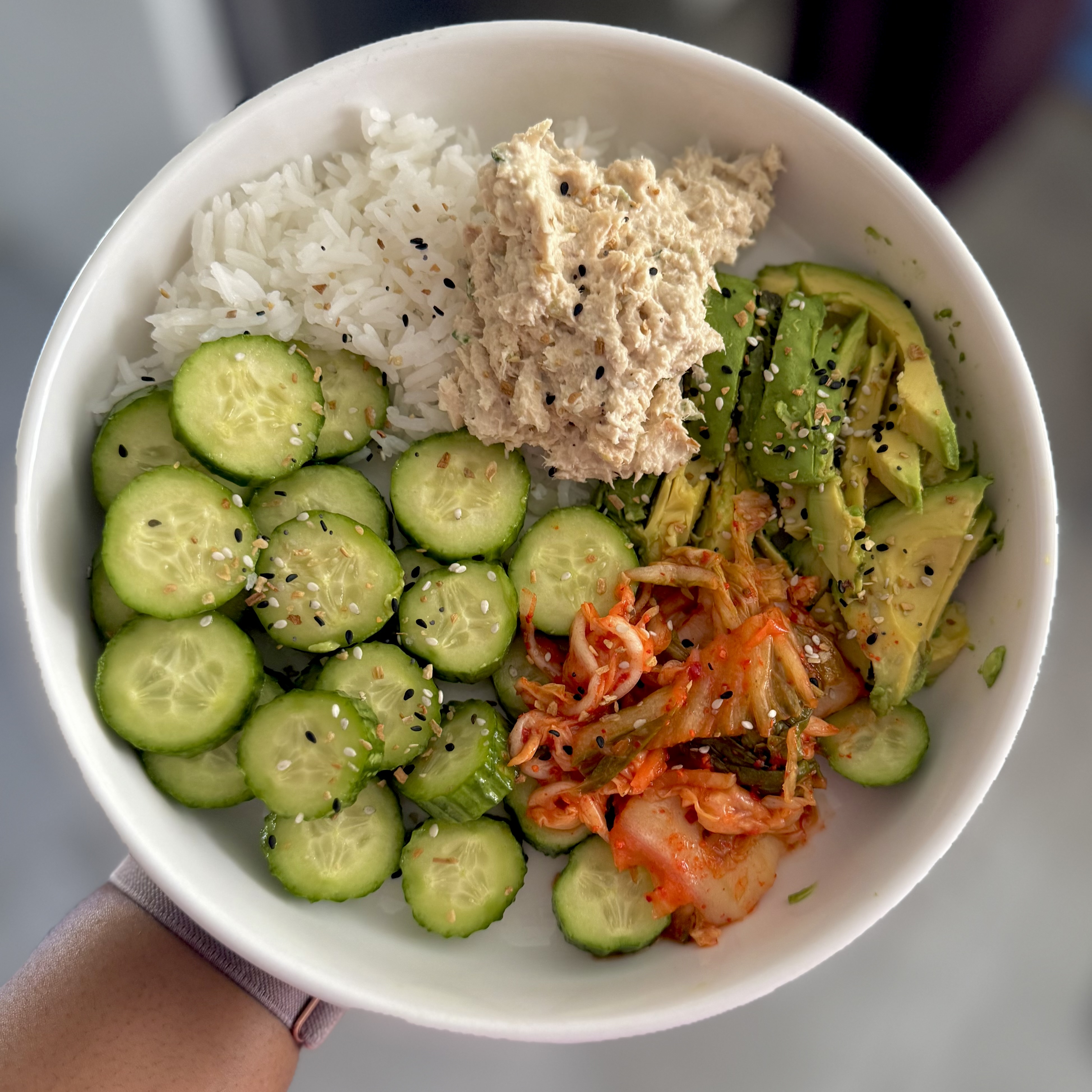 tuna, mini cucumber, rice, kimchi and sliced avocado